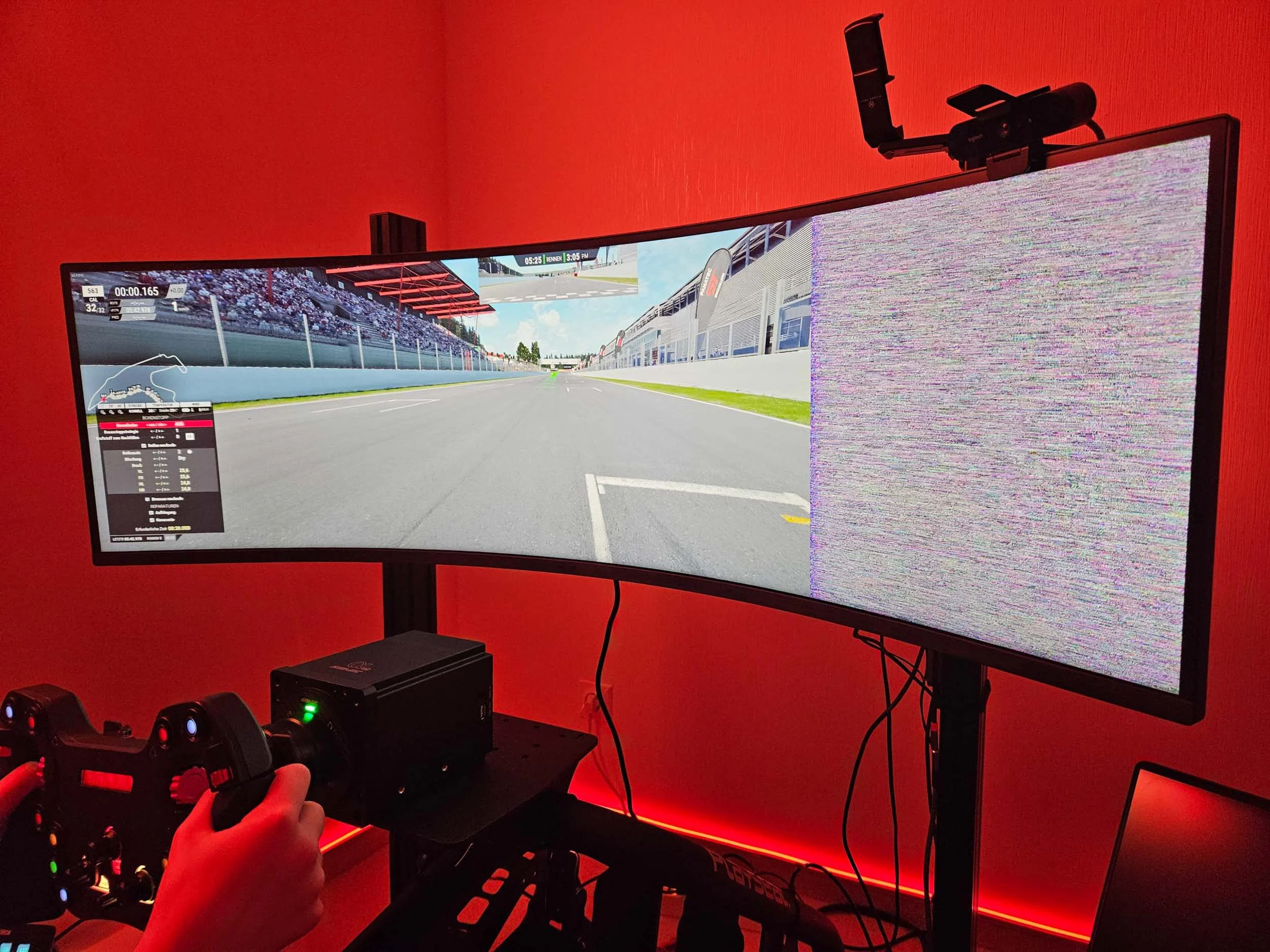 simracingpeterlauritisgt3simulation002 | Lauritisde Hands on a Racing Wheel in Front of a Curved Monitor Showing a Car Race on a Track with Red Ambient Lighting