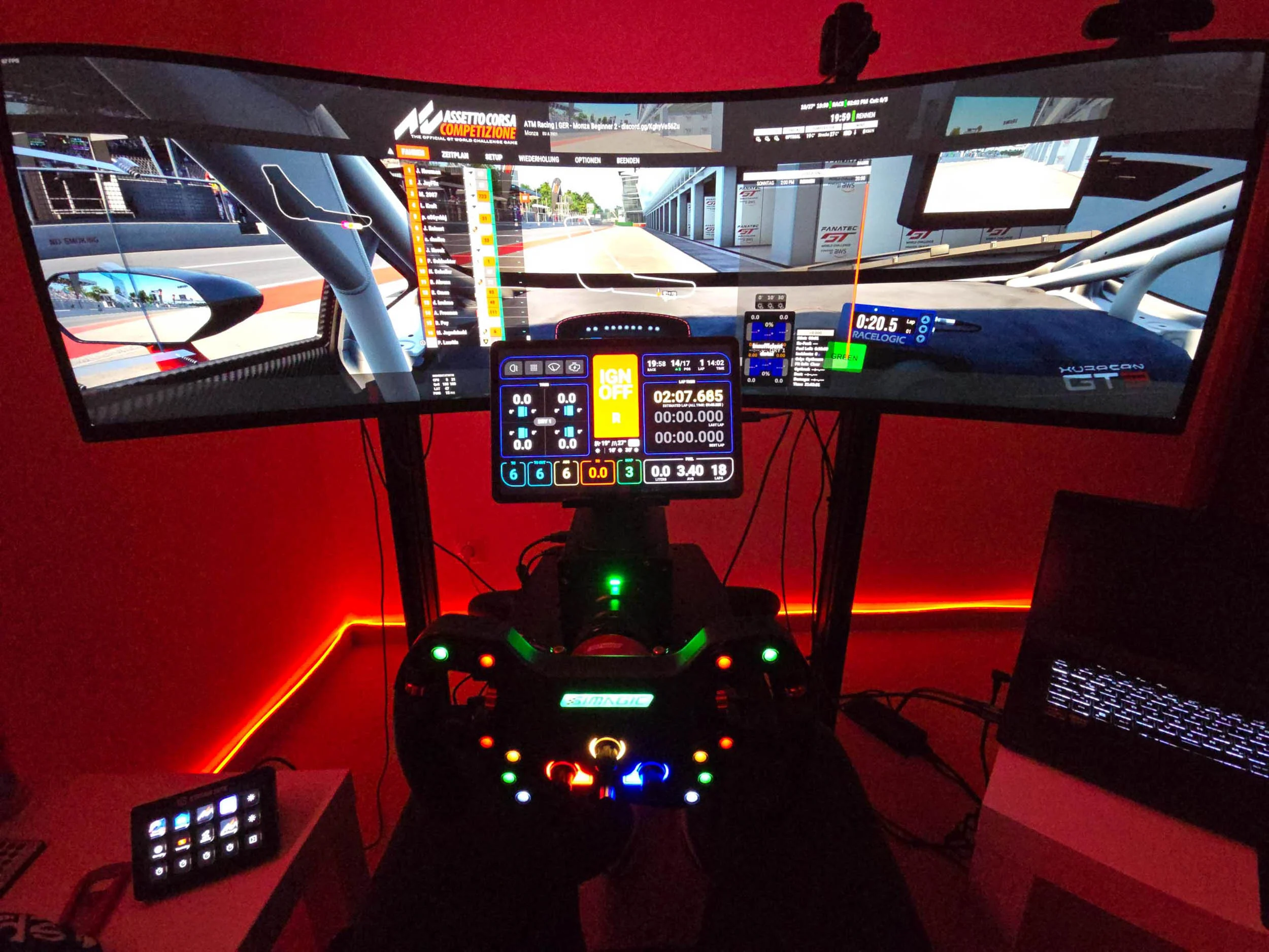 simracingpeterlauritisgt3simulation009 | Lauritisde Triple monitor Racing Simulator Cockpit with a Steering Wheel Pedals and Illuminated Controls Showing a Race Track Scene
