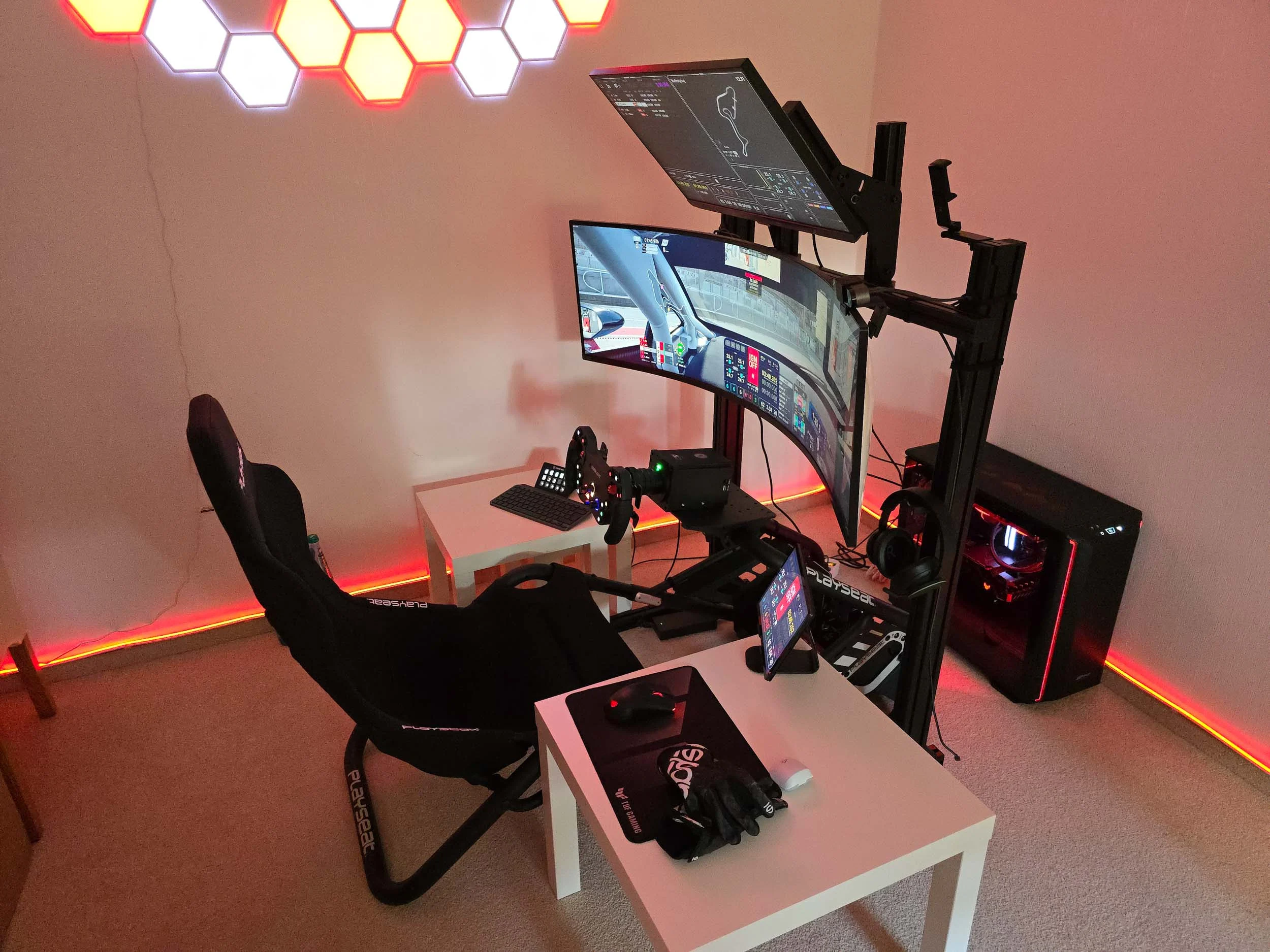 simracingpeterlauritisgt3simulation011 | Lauritisde Home Racing Simulator with Curved Triple Monitors Racing Wheel Pedals and Neon Hex Wall Lights in a Dedicated Setup Room