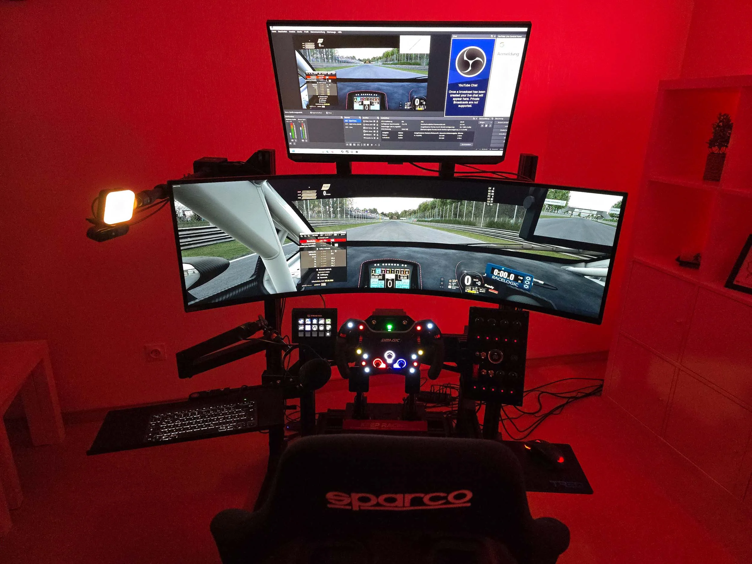 simracingpeterlauritisgt3simulation014 | Lauritisde Triple monitor Racing Simulator Setup in a Red tinted Room Showing a Car Cockpit View and Dashboard Overlays Includes a Sparco Seat Steering Wheel and Pedals