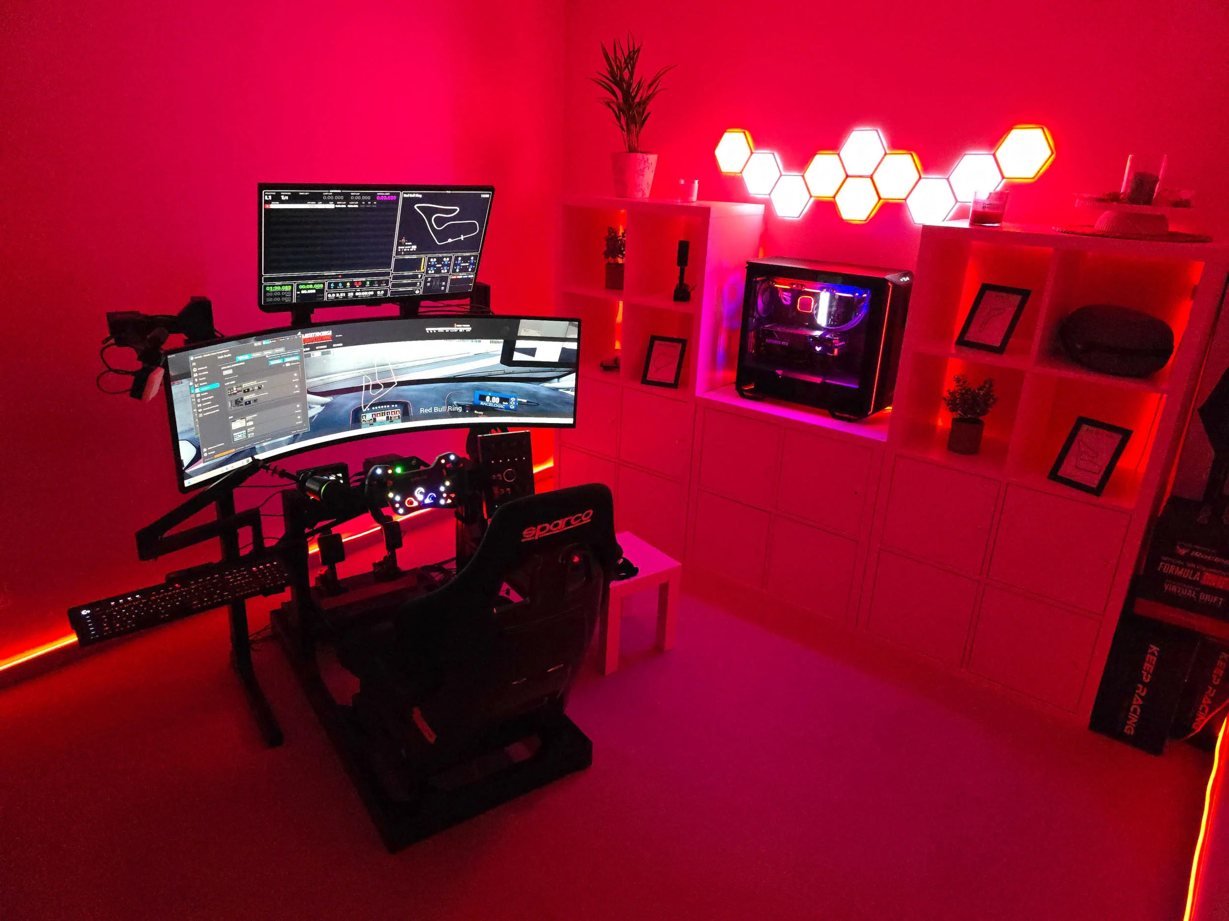 simracingpeterlauritisgt3simulation015 | Lauritisde Red lit Gaming Room Featuring a Racing sim Setup with a Curved Monitor Wheel and Pedals and a Hexagonal Led Wall Decoration on Shelves in the Background