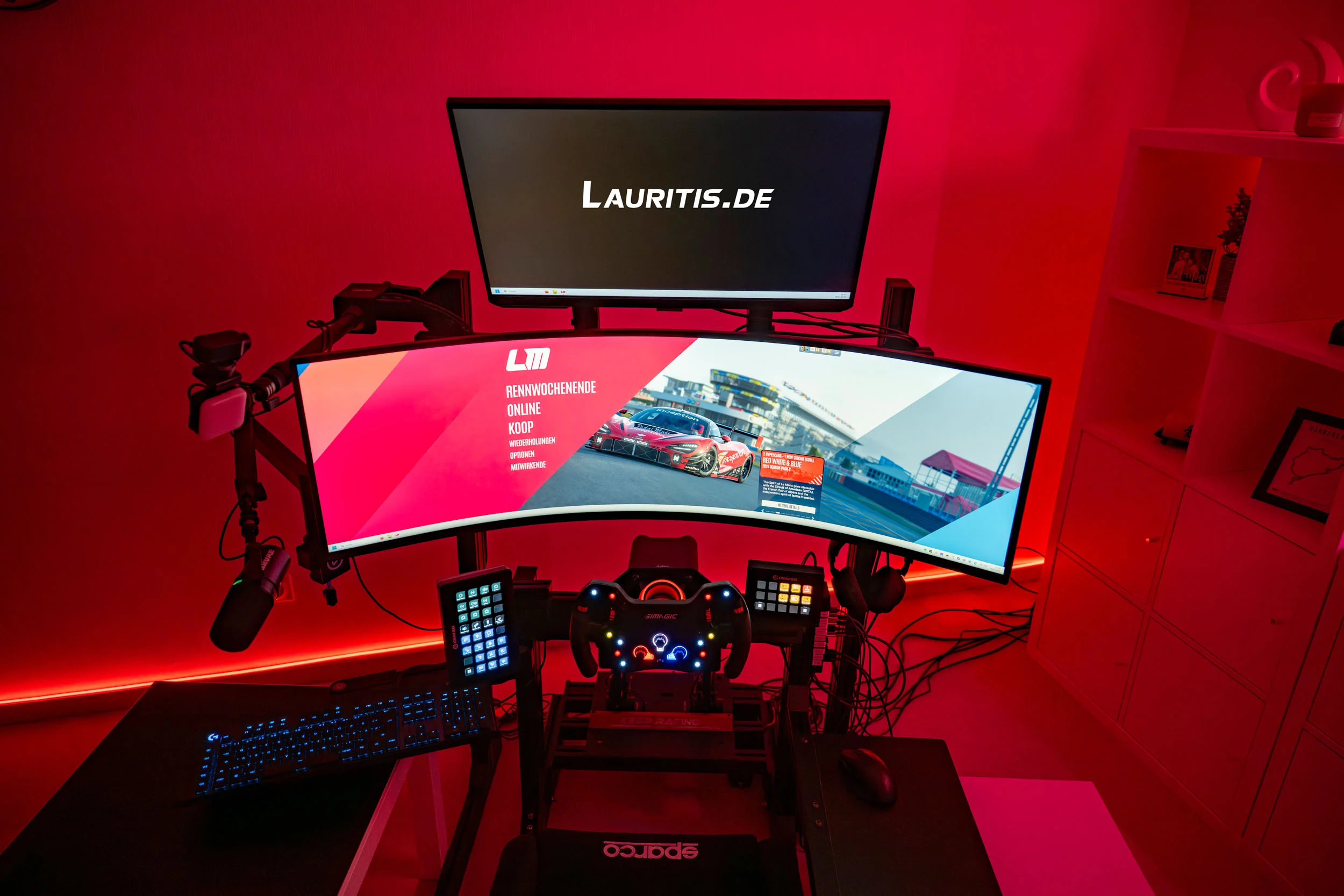 wwwpeterlauritisde | Lauritisde Gamer Workstation with a Curved Monitor Showing a Racing Game Red Ambient Lighting Keyboard Mic and Controllers on a Black Desk Setup